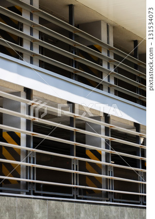 This is a closeup view of a metal fence located within a parking garage This is a closeup view of a metal fence located within a parking garage 131534073