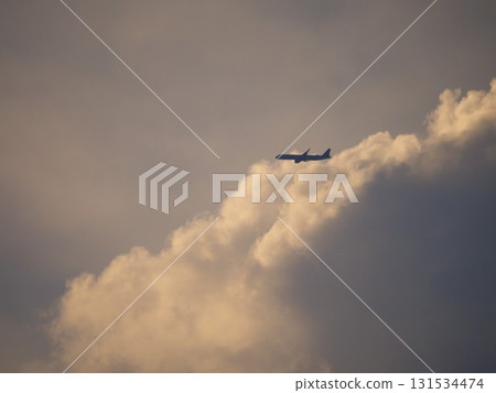 A plane flying towards Haneda through the clouds at dusk A plane flying towards Haneda through the clouds at dusk 131534474