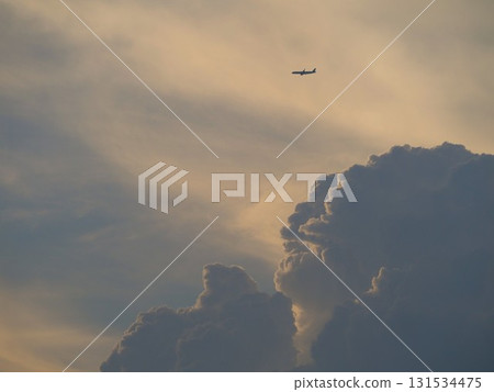 A plane flying towards Haneda through the clouds at dusk A plane flying towards Haneda through the clouds at dusk 131534475
