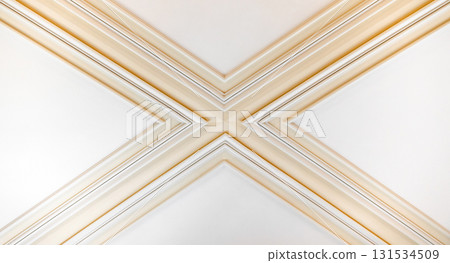 A close-up of decorative architectural molding forming an X-shaped cross 131534509