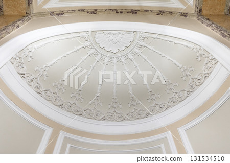 A grand, decorative ceiling dome featuring radial floral plasterwork A grand, decorative ceiling dome featuring radial floral plasterwork 131534510