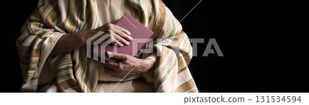 Old man holding a book 131534594