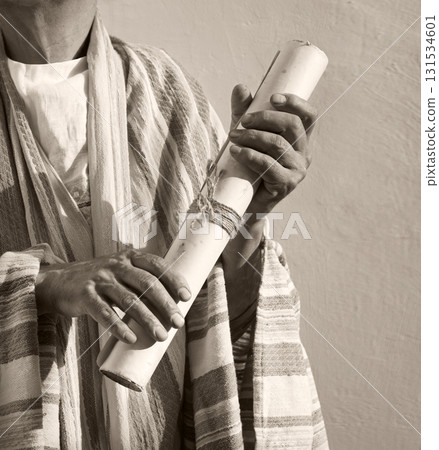 Male hand holding an old scroll 131534601