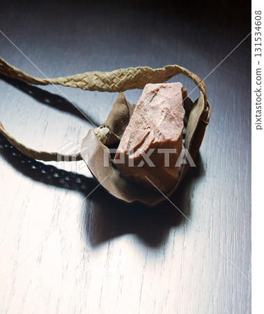 Sling with stone on wooden background Sling with stone on wooden background 131534608