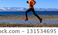 Woman runner training at winter lakeside 131534695