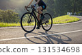 Woman cyclist riding bike in summer park 131534698