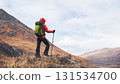 Backpacking woman hiking on winter high altitude mountain top 131534700