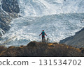 Backpacking woman hiking on winter high altitude mountain top 131534702