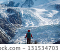 Backpacking woman hiking on winter high altitude mountain top 131534703
