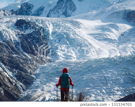 Backpacking woman hiking on winter high altitude mountain top Backpacking woman hiking on winter high altitude mountain top 131534703
