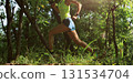 Woman trail runner running at tropical forest mountain peak 131534704
