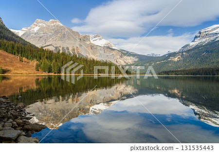 Scenic view of Emerald Lake in Yoho National Park with pine forest and snow-capped mountain with reflected in crystal clear water in Alberta, Canada 131535443