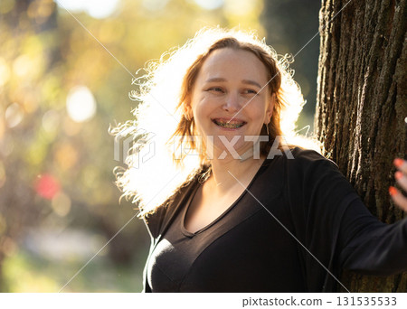 Smiling adult woman expressing confidence with dental braces and speech aid Smiling adult woman expressing confidence with dental braces and speech aid 131535533