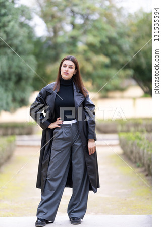 Young woman confidently posing in autumn park 131535594