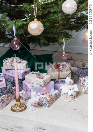 A lively Christmas setting with bright pink and purple presents under a sparkling Christmas tree, evoking happiness and holiday cheer in a colorful celebration 131535846