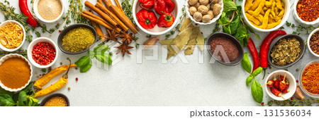 Colorful, fresh herbs and spices framing a gray background, a perfect natural border to bring attention to culinary creativity, top view and copy space, banner 131536034