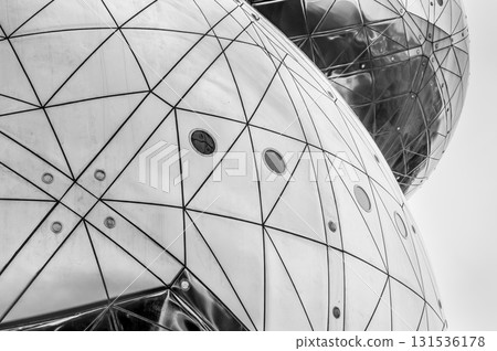 A geometric futuristic abstraction of two metal spheres in perspective. Horizontal black and white photo A geometric futuristic abstraction of two metal spheres in perspective. Horizontal black and white photo 131536178
