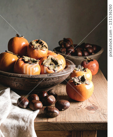 Persimmons and chestnuts on the table Persimmons and chestnuts on the table 131536260