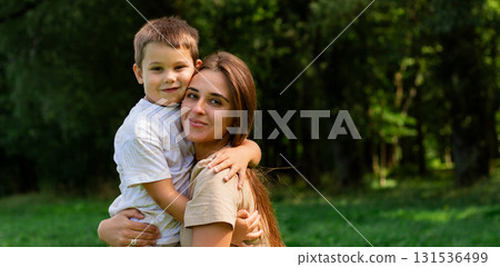 Close up of mother and son exchanging loving whispers and giggles. Perfect illustration of secure attachment and childhood happiness. 131536499