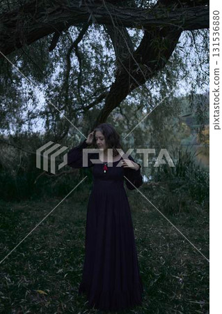 a woman in a black long dress for Halloween, Dracula's bride, vampires, modern witch 131536880