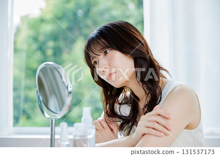 A young woman suffering from skin problems 131537173