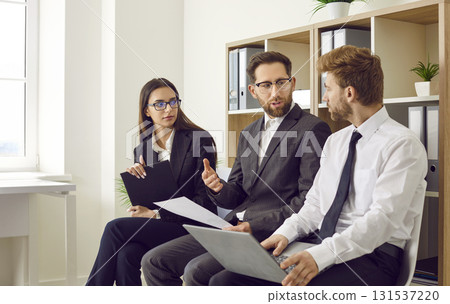 Business people or job seekers sitting in office in row discussing work project and talking. Business people or job seekers sitting in office in row discussing work project and talking. 131537220