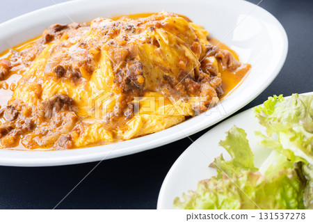 Delicious beef stew sauce, soft-boiled egg omelet rice and salad Delicious beef stew sauce, soft-boiled egg omelet rice and salad 131537278