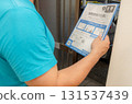 A man looking at an envelope requesting a national tax investigation 131537439