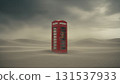 red telephone booth is situated in the middle of a sandy desert surrounded by expansive dunes. Dark stormy clouds create a dramatic atmosphere overhead as the wind blows. 131537933