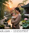 smiling asian woman holds a happy baby in her arms as they stand in a serene garden at sunset. Bamboo trees frame the scene with a traditional house in the background and a lotus flower by the pond. 131537937