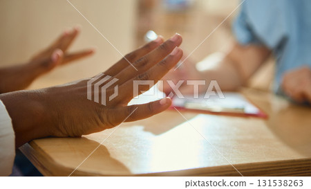Teenage girl expressing feelings with hands during child therapy session Teenage girl expressing feelings with hands during child therapy session 131538263