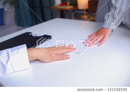 Female employee deliver a resignation letter in a white envelop to her manager or HR department when she decides to quit, resigned from her job. Female employee deliver a resignation letter in a white envelop to her manager or HR department when she decides to quit, resigned from her job. 131538509