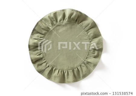 Cooking green round kitchen napkin or towel with ruffle isolated on white background. Top view. Cooking green round kitchen napkin or towel with ruffle isolated on white background. Top view. 131538574