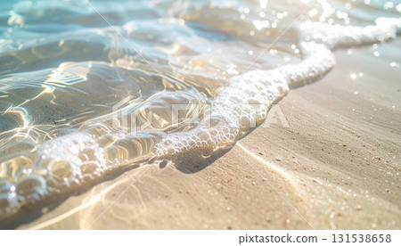Close-up view of gentle ocean waves washing onto a sandy beach with clear water reflections and foam du daylight, peaceful seaside shoreline scene 131538658