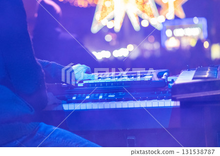 Man plays keayboard at outdoor Christmas festival at Night Man plays keayboard at outdoor Christmas festival at Night 131538787