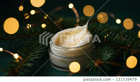 Luxurious winter skin cream with gold glitter and pine boughs for holiday rejuvenation and radiant beauty, perfect for festive beauty ads 131539479