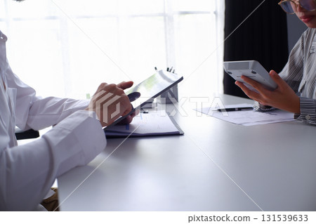 Two businesspeople accountant coworker work in office consulting meeting brainstorming report analyze Two businesspeople accountant coworker work in office consulting meeting brainstorming report analyze 131539633