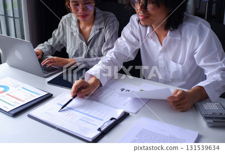 Two businesspeople accountant coworker work in office consulting meeting brainstorming report analyze Two businesspeople accountant coworker work in office consulting meeting brainstorming report analyze 131539634