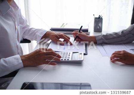 Two businesspeople accountant coworker work in office consulting meeting brainstorming report analyze Two businesspeople accountant coworker work in office consulting meeting brainstorming report analyze 131539687