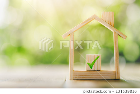 Mortgage and loan approved concept: Wooden model house place on the table. planning savings money of coins to buy a home concept for property. Mortgage and loan approved concept: Wooden model house place on the table. planning savings money of coins to buy a home concept for property. 131539816