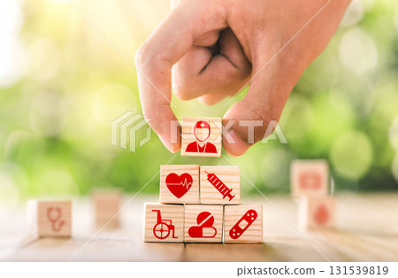 Hand arranged wooden blocks with icons of medical health. health insurance for your health concept. Healthcare medical business. 131539819