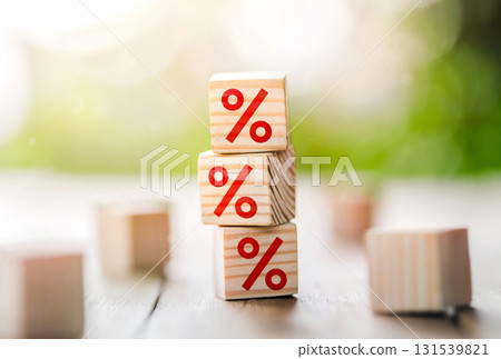Interest rate financial and mortgage rates concept. Wooden cube block increasing on top with icon percentage symbol upward direction. Interest rate financial and mortgage rates concept. Wooden cube block increasing on top with icon percentage symbol upward direction. 131539821