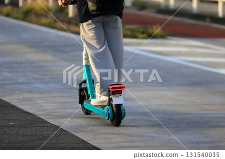 Image of an electric kickboard running on the road 131540035