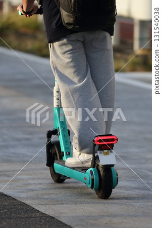 Image of an electric kickboard running on the road 131540038