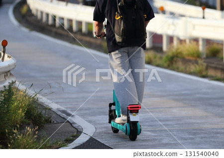 Image of an electric kickboard running on the road Image of an electric kickboard running on the road 131540040