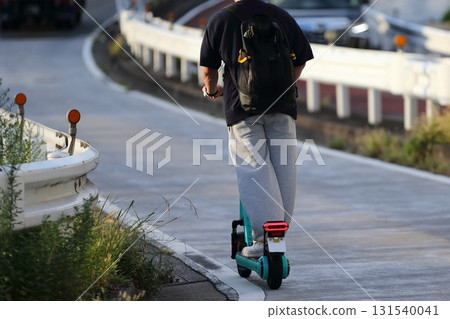 Image of an electric kickboard running on the road 131540041