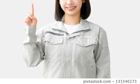 A young woman wearing work clothes and folding her arms A young woman wearing work clothes and folding her arms 131540173