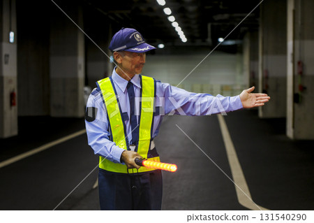 A security guard directing traffic A security guard directing traffic 131540290