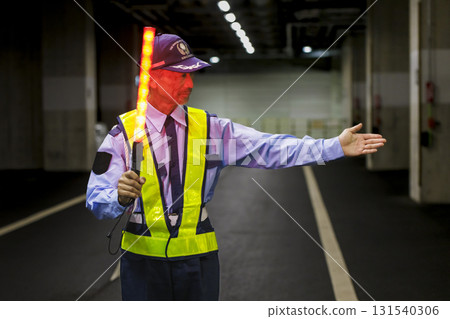 A security guard directing traffic 131540306