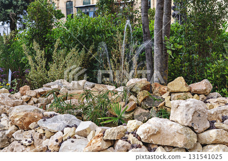 Rock garden installation with fountain at Valletta Malta green festival with stones and plants 131541025
